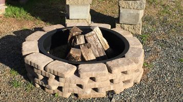 Chitwood Dirt Yard | Rock Hill, SC | concrete blocks formed in a circle for a fire pit with wood in the center