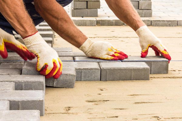 Chitwood Dirt Yard | Rock Hill, SC | workers laying down concrete pavers in yard